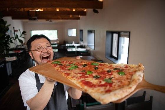 '강식당' 규현의 피자 스승으로도 유명한 이진형 셰프가 본인의 시그너처인 대형 피자를 들어보이고 있다. 사진제공 핏제리아 오
