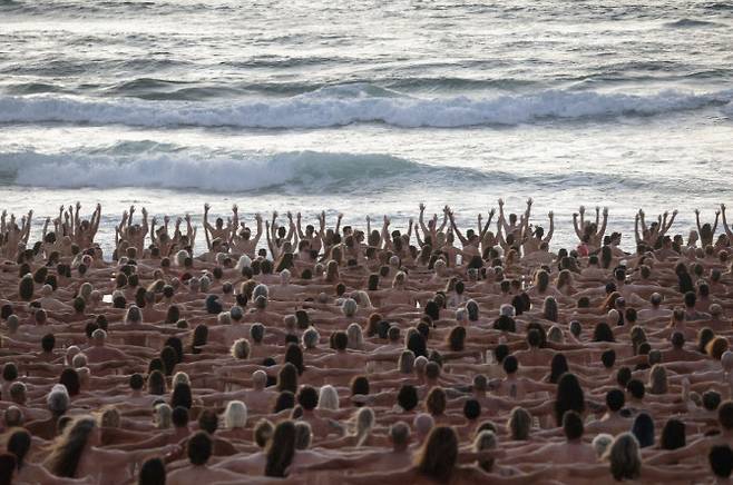26일(현지시간) 호주 시드니의 본다이 비치에서 피부암에 대한 인식을 높이고 피부 검사를 받도록 장려하기 위해 예술가 스펜서 튜닉의 설치 미술의 일부로 사람들이 알몸으로 서 있는 모습. (사진=로이터)