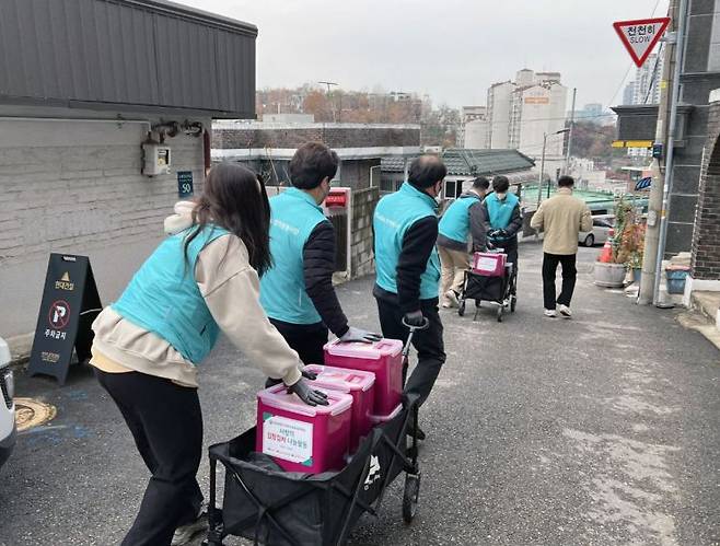 김장김치 나눔 행사에 참여한 KT알파 임직원들이 지원 물품을 준비하고 있다. (사진제공=KT알파)