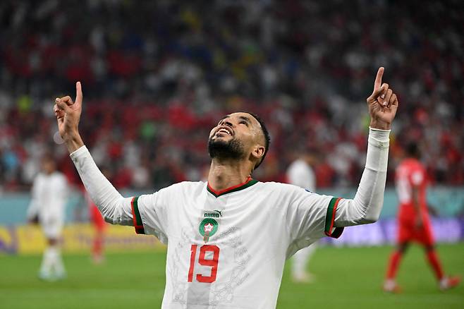 TOPSHOT - Morocco's forward #19 Youssef En-Nesyri celebrates scoring a goal which was later disallowed during the Qatar 2022 World Cup Group F football match between Canada and Morocco at the Al-Thumama Stadium in Doha on December 1, 2022. (Photo by Patrick T. Fallon / AFP)