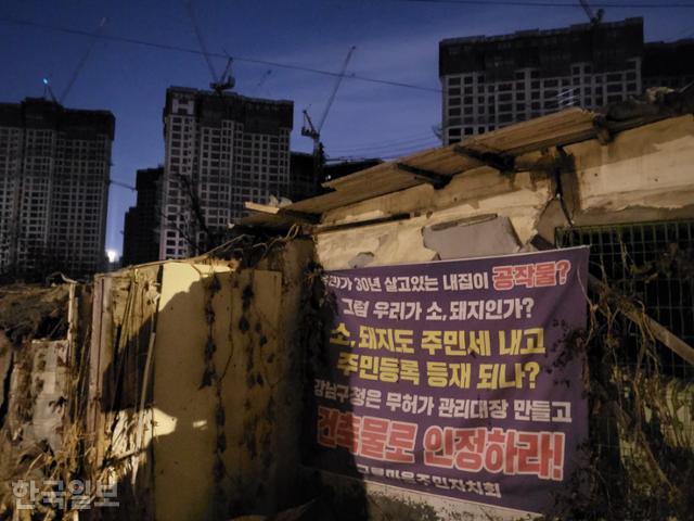 지난달 28일 서울 강남구 구룡마을 입구에 무허가 주택을 건축물로 인정할 것을 촉구하는 현수막이 걸려 있다. 강지수 기자