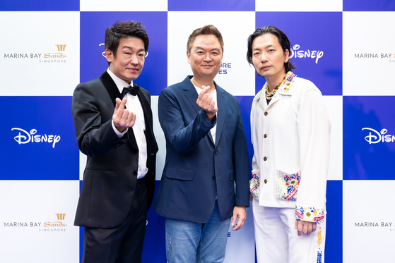 From left, actor Heo Sung-tae, director Kang Yun-sung and actor Lee Dong-hwi pose at the blue carpet event for the Disney Content Showcase held at Marina Bay Sands Singapore on Thursday. [THE WALT DISNEY COMPANY]