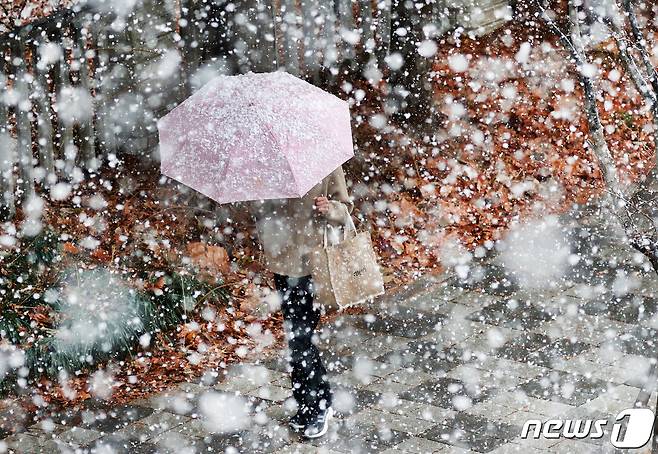수도권 지역에 많은 눈이 내린 13일 오후 경기도 수원시 거리를 지나는 시민이 발걸음을 재촉하고 있다. 2022.12.13/뉴스1 ⓒ News1 김영운 기자