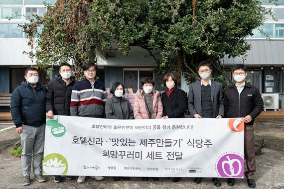 26일 ‘맛있는 제주만들기’의 식당주와 호텔신라 임직원들이 서귀포시 소재 제남아동센터를 방문해 아이들에게 쿠키세트와 학용품이 담긴 ‘희망꾸러미’를 전달하고 기념사진을 찍었다. (왼쪽 네번째부터) 제남아동센터 윤정자 원장, 맛제주 10호점 강순옥 식당주, 호텔신라 김희연 사원대표. 호텔신라 제공.