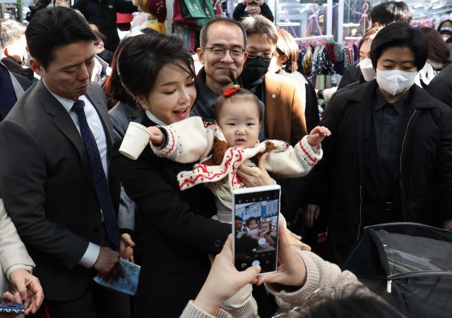 윤석열 대통령 부인 김건희 여사가 11일 대구 중구 서문시장을 찾아 아이를 안아주고 있다. 연합뉴스