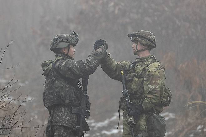 경기도 파주 무건리훈련장에서 13일 실시된 아미타이거 시범여단과 미국 스트라이커 여단의 연합훈련에서 한미 장병들이 목표 확보 후 악수를 나누고 있다. [육군 제공]