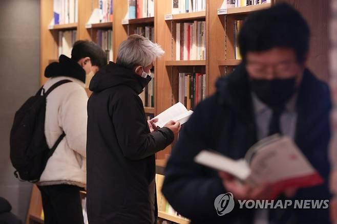 내일 실내 마스크 착용의무 조정 논의 (서울=연합뉴스) 서대연 기자 = 이날 서울 시내 한 대형서점에서 마스크를 쓰고 책을 읽는 시민들. 2023.1.16 dwise@yna.co.kr