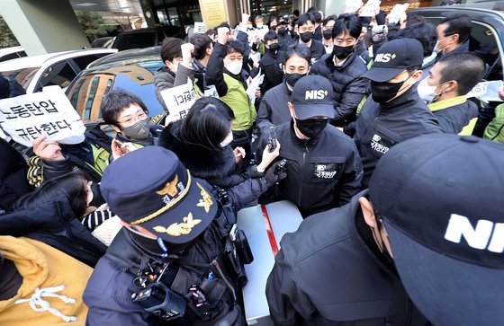 국가정보원 직원들이 지난 18일 오후 서울 영등포구 민주노총 전국보건의료산업노동조합 사무실에서 국가보안법 위반 혐의 관련 압수수색을 마친 뒤 압수품을 옮기고 있다. 연합뉴스