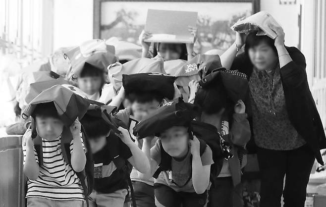 2019년 송림초등학교에서 열린 ‘제411차 민방위의 날 대테러(대피) 훈련’에 참석한 선생님과 학생들이 운동장으로 대피하는 훈련을 하고 있다.
