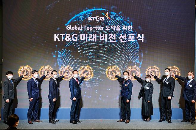 KT&G가 26일 서울 성동구 성수동 KT&G 상상플래닛에서 ‘KT&G 미래 비전 선포식’을 열고, 글로벌 ‘톱 티어(Top-Tier)’ 기업으로의 도약을 위한 그룹 목표와 청사진을 공개했다. 백복인(왼쪽 네 번째) 사장을 비롯한 KT&G 임직원들이 미래 비전 선포식 행사 후 기념 세리머니를 하고 있는 모습. [KT&G 제공]