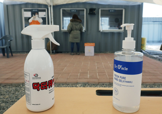 Hand sanitizers sit on a desk of a Covid-19 testing center in Gangseo District, western Seoul on Sunday. [NEWS1]