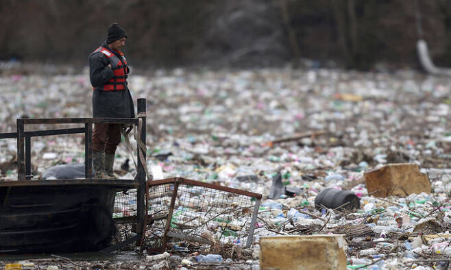세르비아 림강에 떠내려온 플라스틱 폐기물이 가득 쌓여 있다. 전 세계 플라스틱 쓰레기 중 9%만 재활용되는 현실 속에 존 도어는 2050년까지 플라스틱의 온실가스 배출량을 80%까지 낮추는 것을 목표로 제시한다. AP연합뉴스