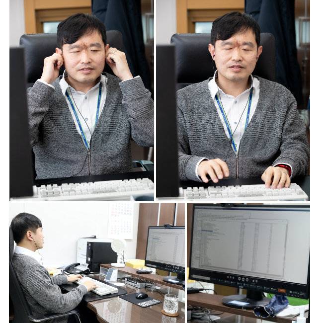 김동현 판사가 자신의 책상 앞에 앉아 사건 자료를 귀로 들으며 판결문을 작성하고 있다. [지호영 기자]