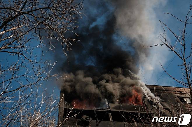 8일(현지시간) 우크라이나 도네츠크 아우디우카에서 러시아 군의 포격을 받은 건물서 불길과 연기가 솟아 오르고 있다. ⓒ AFP=뉴스1 ⓒ News1 우동명 기자