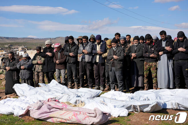 7일(현지시간) 시리아 이스칸다르에서 유족과 이웃들이 숨진 이들을 애도하고 있다. 식구 일곱 명 중 유일한 생존자는 신생아 '아야' 뿐이었다. ⓒ AFP=뉴스1 ⓒ News1 권진영 기자