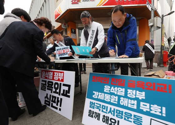 지난 11일 오후 광주 동구 충장로우체국 앞에서 강제동원 정부 해법에 반대하는 시민들이 서명을 하고 있다. 연합뉴스