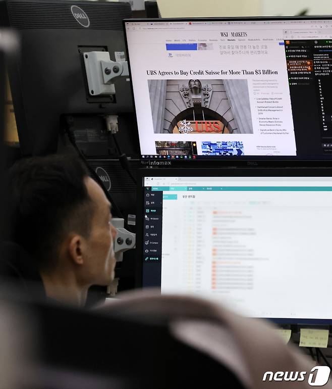 (서울=뉴스1) 구윤성 기자 = 20일 오전 서울 중구 하나은행 명동점 딜링룸에서 직원이 UBS의 크레디트스위스(CS) 인수 관련 뉴스를 살피고 있다.   스위스 최대 금융기관 UBS는 미국 실리콘밸리은행(SVB) 파산 여파로 위기에 빠진 세계적 투자은행 CS를 32억 달러에 인수했다. 2023.3.20/뉴스1  Copyright (C) 뉴스1. All rights reserved. 무단 전재 및 재배포 금지.