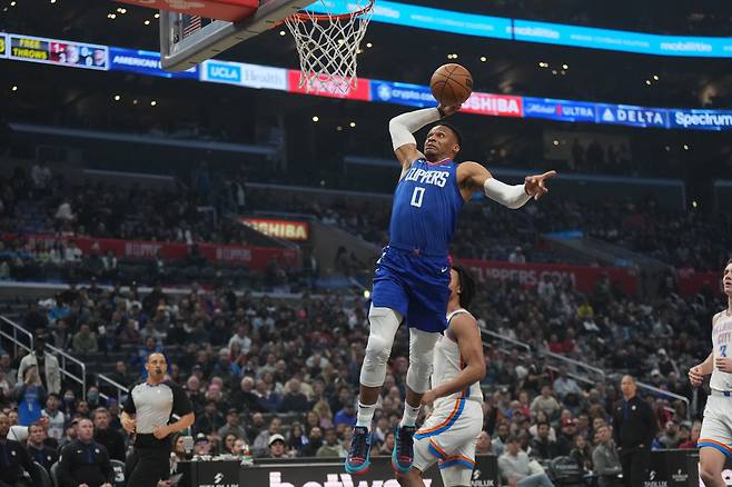 Mar 21, 2023; Los Angeles, California, USA; LA Clippers guard Russell Westbrook (0) dunks the ball against the Oklahoma City Thunder in the first half at Crypto.com Arena. Mandatory Credit: Kirby Lee-USA TODAY Sports