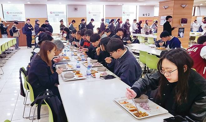 학생들이 학교 관계자들과 함께 식사 중이다.