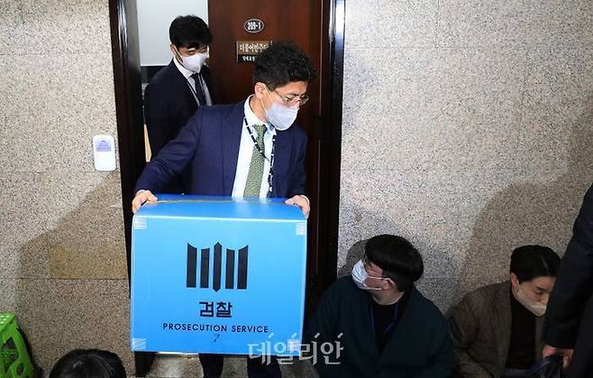 검찰이 정진상 전 더불어민주당 당대표 정무조정실장의 사무실 압수수색을 마친 뒤 압수물을 들고 나오고 있다. ⓒ데일리안 박항구 기자