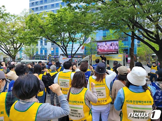 11일 오전 부산시청 앞 광장에서 열린 '부산시 발달장애인 권리기반 지원체계 구축을 촉구하는 결의대회'에서 참석자들이 성명서를 읽고 있다.2023.4.11/뉴스1 ⓒ News1 조아서 기자