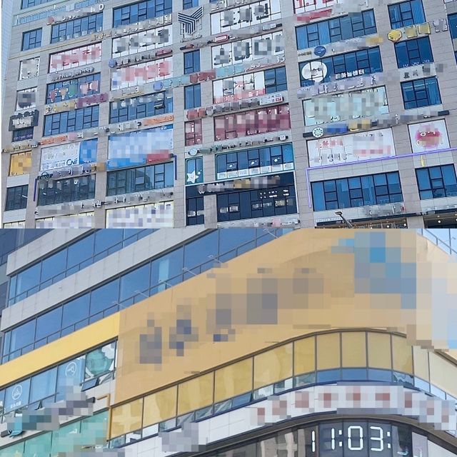 인천 중구 중산동의 병원과 학원 등이 영업중인 건물 창문에 업소 광고용 시트지로 뒤덮여 있다. 박주연기자