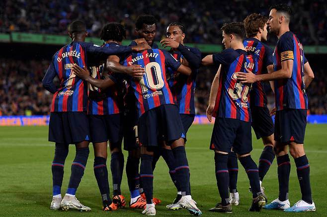 Barcelona's players celebrate a goal during the Spanish league football match between FC Barcelona and Real Betis at the Camp Nou stadium in Barcelona on April 29, 2023. (Photo by Josep LAGO / AFP)