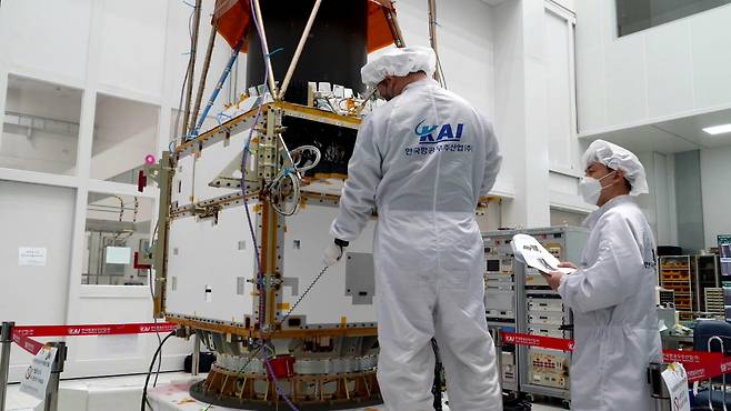 Officials at Korea Aerospace Industries work on a satellite. (Korea Aerospace Industries)