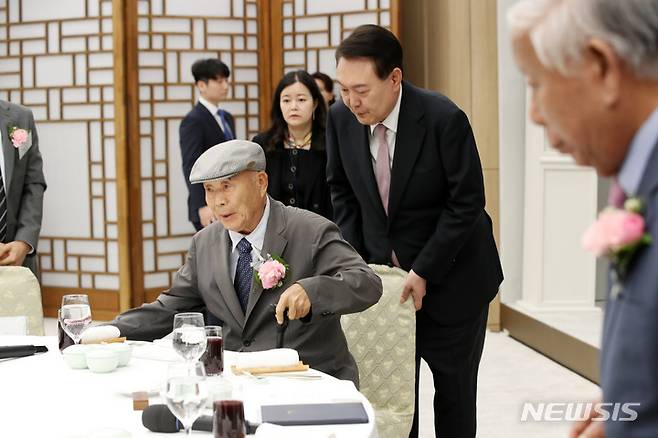 [서울=뉴시스] 전신 기자 = 윤석열 대통령이 15일 서울 용산 대통령실 청사에서 열린 제42회 스승의 날 기념 현장교원 초청 오찬 간담회에서 윤 대통령의 충암고 시절 은사인 최윤복 선생님의 착석을 도와주고 있다. 2023.05.15. photo1006@newsis.com