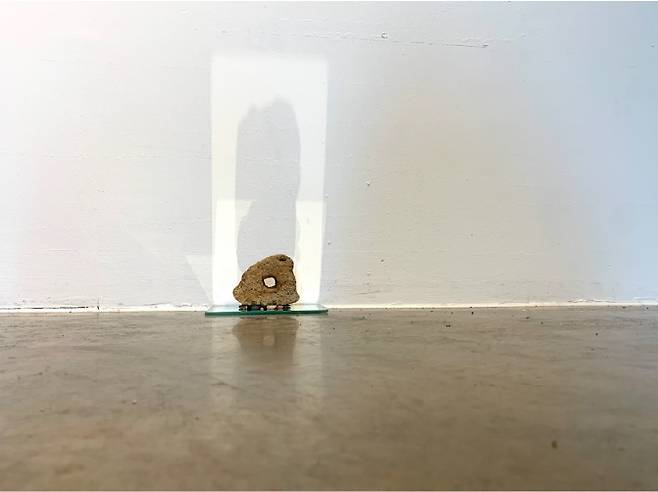 김우경, '잠 깬 돌'. 구멍 난 돌, 둥근 돌, 거울, 21.5x50cm, 2023 (신한갤러리 제공)