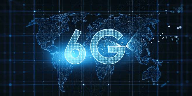 Global wireless and high speed internet connection concept with digital glowing 6g symbol on world map technological background.