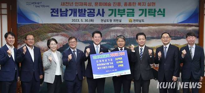 김영록(가운데) 전남도지사가 30일 오전 도청 접견실에서 장충모(오른쪽 네 번째) 전남개발공사 사장으로부터 기부금을 기탁받고 있다. 사진=전남도