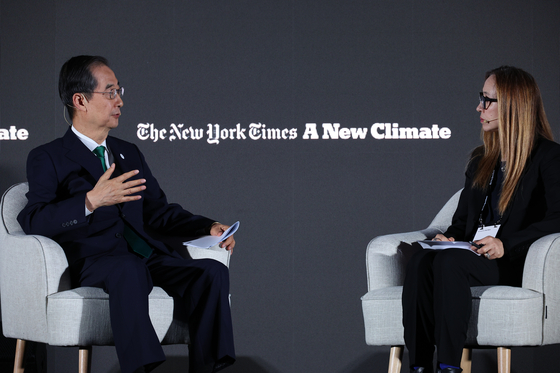 Prime Minister Han Duck-soo, left, speaks during the New York Times A New Climate event held at Bexco, Busan, on May 25. [YONHAP]