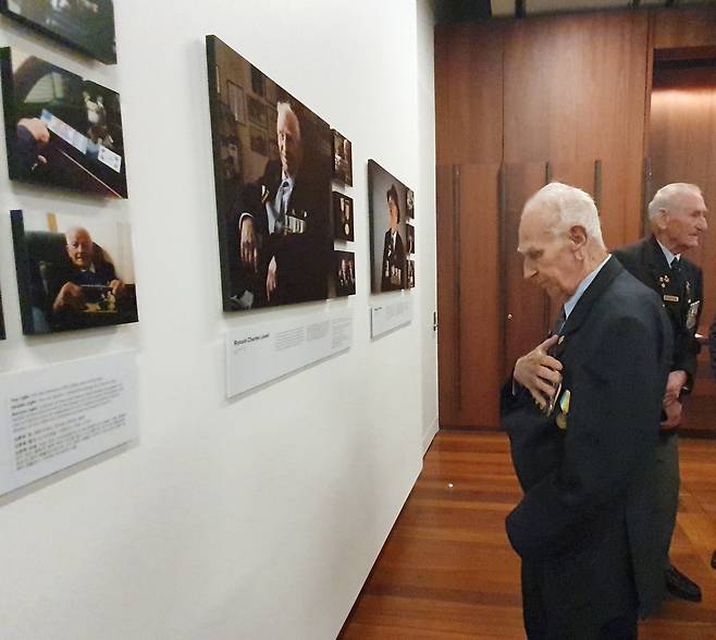 호주 참전용사 인물사진전 (시드니=연합뉴스) 정동철 통신원 = 지난 2일(현지시간) 호주 시드니 안작 메모리얼에서 열린 참전용사 인물사진전 개막식에 참석한 참전용사 로널드 찰스 러벨씨가 자신의 사진 앞에서 전장에서 돌아오지 못한 전우들을 위한 묵념을 올리고 있다. 2023.06.02. dcj@yna.co.kr