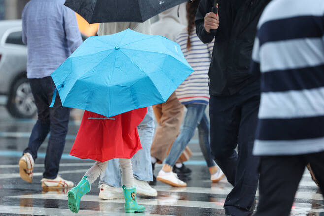 지난달 27일 오후 서울 광화문네거리에서 어린이가 우산을 쓰고 횡단보도를 건너고 있다. [사진 출처 = 연합뉴스]