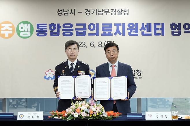 8일 성남시청에서 열린 통합응급의료지원센터 협약식에서 신상진(오른쪽) 시장과 홍기현 경기남부경찰청장이 협약서를 들어 보이고 있다. 성남시 제공