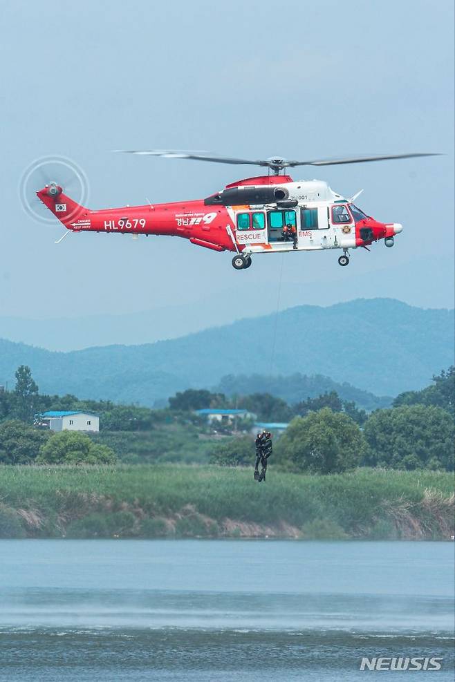 [합천=뉴시스] 홍정명 기자 = 경상남도소방본부 119항공대 대원들이 22일 합천군 소재 황강에서 여름철 수난사고 대비 소방헬기 활용 인명구조훈련을 하고 있다.(사진=경상남도소방본부 제공) 2023.06.22. photo@newsis.com