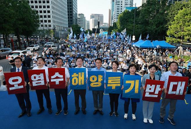 이재명 대표(왼쪽 네 번째부터)와 박광온 원내대표 등 더불어민주당 지도부가 1일 오후 서울 중구 숭례문 일대에서 열린 ‘일본 후쿠시마 원전 오염수 해양투기 규탄 범국민대회’에서 손팻말을 든 채 무대에서 상징의식을 펼치고 있다.(사진=연합뉴스 제공)