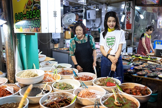 윤석열 대통령 부인 김건희 여사가 어제(3일) 오후 강원도 강릉 중앙·성남시장을 방문해 반찬을 살펴보고 있다. (사진 출처 : 뉴시스)