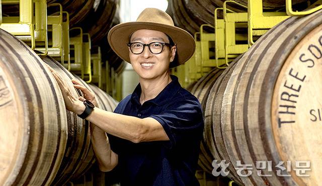 도정한 쓰리소사이어티스 대표가 위스키 저장창고이자 다양한 연구가 진행되고 있는 연구개발(R&D)센터의 오크통 사이에서 활짝 웃고 있다.
