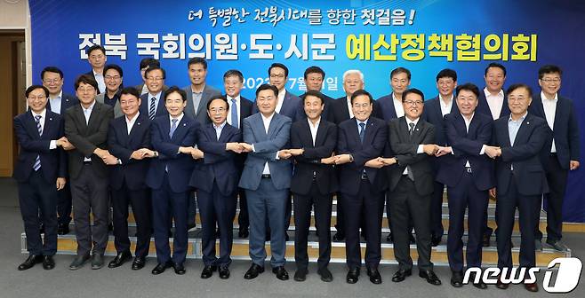 11일 전북 전주시 전북도청에서 열린 전북 국회의원·도·시군 예산정책협의회에서 김관영 전북도지사와 전북지역 국회의원, 시장군수들이 손을 맞잡고 기념촬영을 하고 있다. 2023.7.11/뉴스1 ⓒ News1 유경석 기자