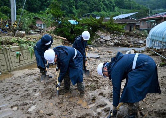 수해복구에 나선 공군16전투비행단 장병들이 16일 경북 예천군 주택가에서 토사를 걷어내고 있다. 공군 제공