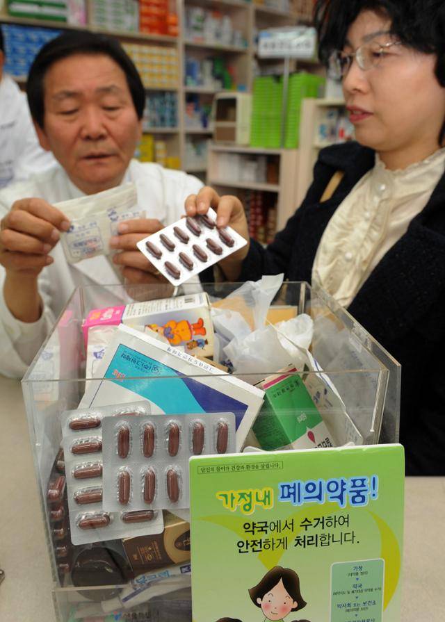 폐의약품 회수·처리 사업이 본격화된 2009년 서울 영등포구 한 약국에서 약사가 폐의약품을 가져온 시민에게 사용 가능한 약인지 여부를 확인해주고 있다. 최흥수 기자