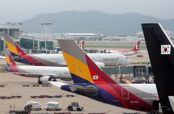 Asiana Airlines planes are parked at a ramp in Incheon International Airport on Sunday. [NEWS1]