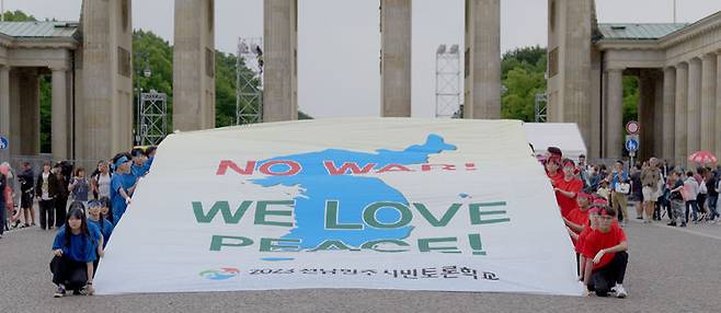 [무안=뉴시스] 전남교육청은 민주시민토론학교 국외 캠프단 80명의 학생들이 독일 베를린 파리저 광장 브란덴부르크 문에서 평화와 공존 메시지를 담은 전통놀이 퍼포먼스를 선보였다고 24일 밝혔다. (사진=전남교육청 제공). photo@newsis.com *재판매 및 DB 금지