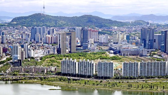 올 상반기 서울 용산구의 땅값은 동시다발적으로 추진되는 개발 호재 덕에 소폭 올랐다. 사진은 서울 여의도 63빌딩에서 바라본 용산 정비창 부지(한강변 아파트 뒤) 모습. 연합뉴스