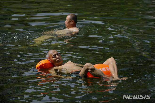 [베이징=AP/뉴시스] 6일 중국 베이징 주민들이 수로에서 물놀이를 하며 무더위를 식히고 있다. 베이징의 기온이 40도에 이를 것으로 예보되자 시 정부는 기업들에 야외 작업 중단 명령을 내렸다. 2023.07.06.