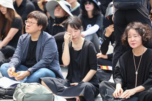 29일 서울 종로구 경복궁역 사거리 인근에서 열린 공교육 정상화를 위한 집회에서 한 참가자가 고인이 된 서이초 담임교사를 위한 추모영상을 보며 눈시울을 붉히고 있다. 연합뉴스