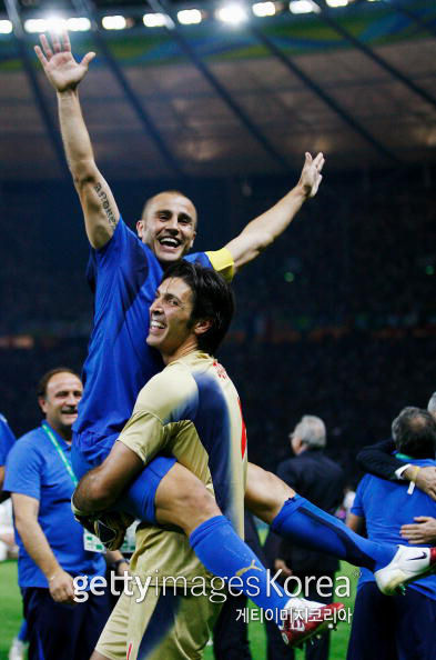 BERLIN - JULY 09: Fabio Cannavaro of Italy celebrates his team's victory in a penalty shootout with Goalkeeper Gianluigi Buffon at the end of the FIFA World Cup Germany 2006 Final match between Italy and France at the Olympic Stadium on July 9, 2006 in Berlin, Germany. (Photo by Shaun Botterill/Getty Images)