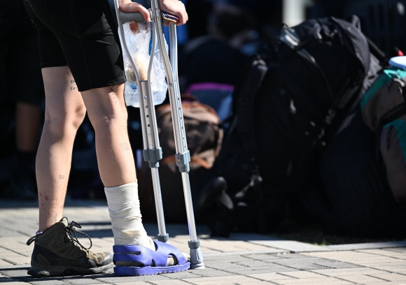 8일 오전 전북 부안군 새만금 세계스카우트 잼버리 야영지에서 나온 한 스카우트 대원이 목발을 짚은 채 버스에 탑승하기 위해 기다리고 있다. 2023.8.8. 도준석 기자